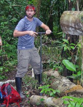 Researcher Jake Schiferl uses a soil augur to extract samples from the flood-plain forest of Peru.